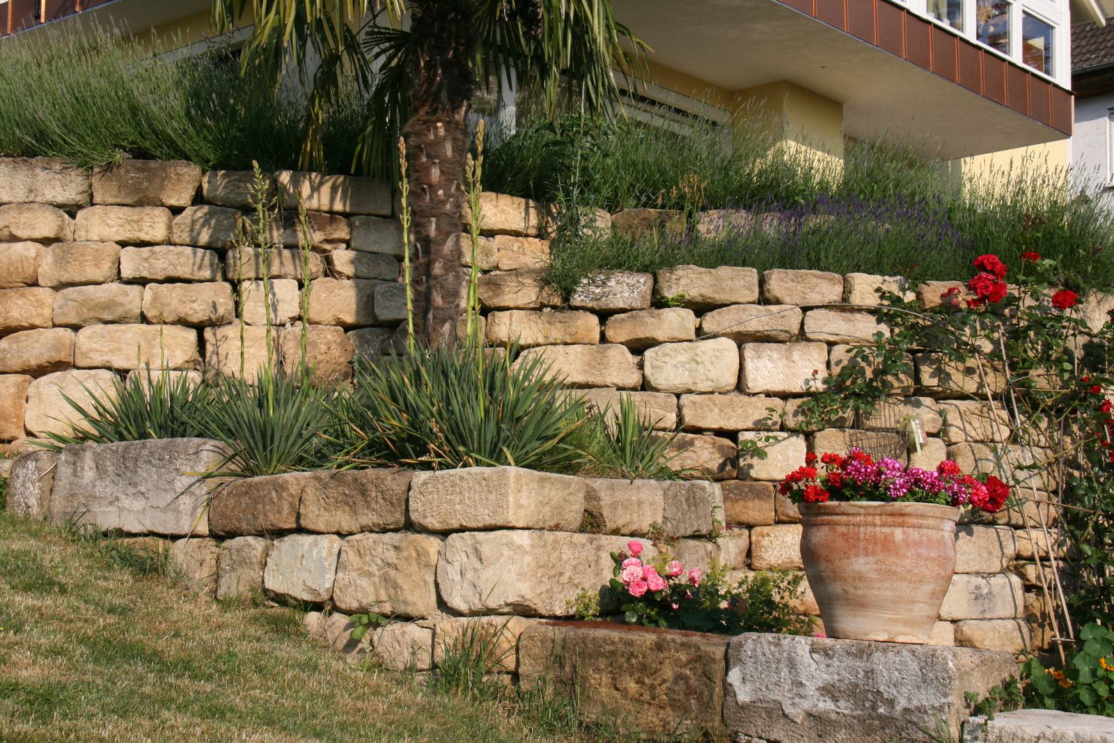 Steinfigur mit Fels als Gartendekoration