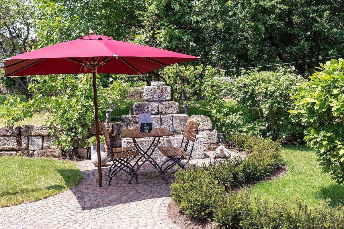 Café-Garten mit rotem Sonnenschirm
